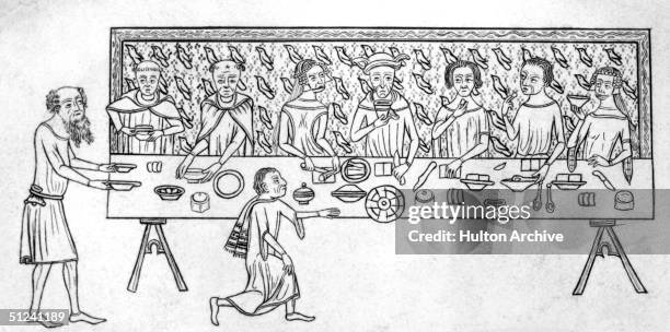 Circa 1350, Servants bring food to their master's table during a banquet. Original Publication: From the Luttrell Psalter.