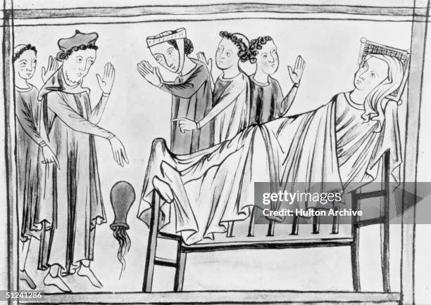 Circa 1400, An Anglo Norman doctor drops a container while attending to a patient in their sick bed.