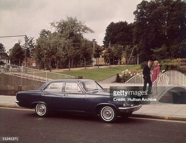 Circa 1967, A couple admiring a new Vauxhall Cresta PC saloon car.
