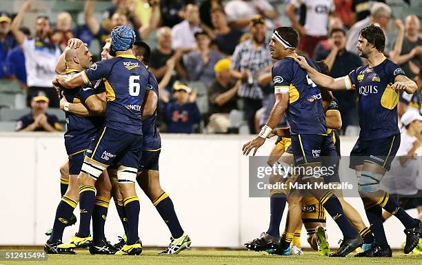 Stephen Moore of the Brumbies celebrates with team mates after David Pocock scores a try during the round one Super Rugby match between the Brumbies...