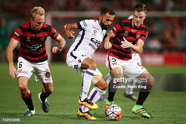 Mitch Nichols and Scott Jamieson of the Wanderers compete for the ball against Diego Castro of Perth Glory during the round 21 A-League match between...