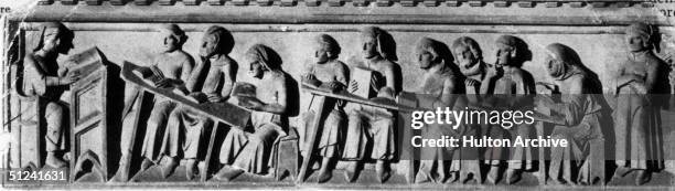 Circa 1375, Part of a lesson in progress at Bologna University in northern Italy. Original Publication: From a bas-relief by Cellino di Nese.