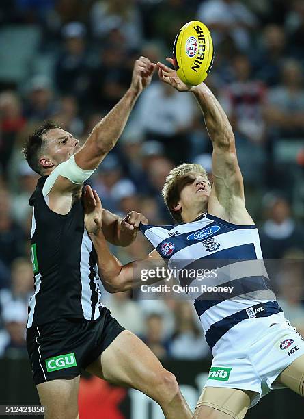 Nathan Brown of the Magpies and Rhys Stanley of the Cats compete for a mark during the 2016 NAB Challenge match between the Geelong Cats and the...