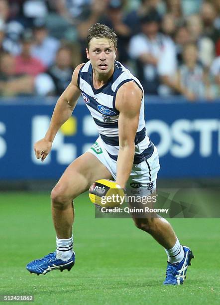 Mitch Duncan of the Cats handballs during the 2016 NAB Challenge match between the Geelong Cats and the Collingwood Magpies at Simonds Stadium on...
