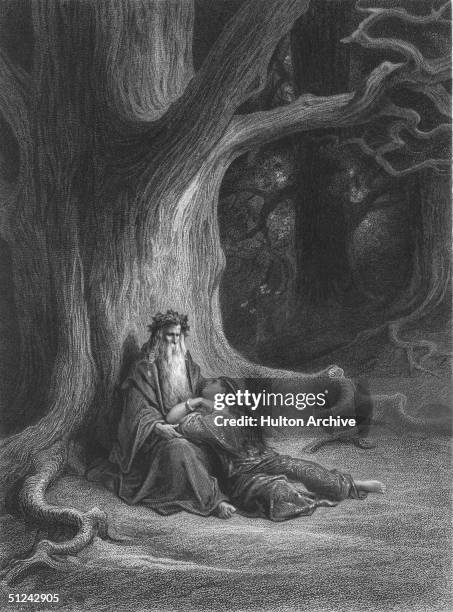 Circa 540 AD, Vivian lying at the feet of Merlin under a large tree, in an illustration from an Arthurian Legend. Original Artwork: Engraved by...