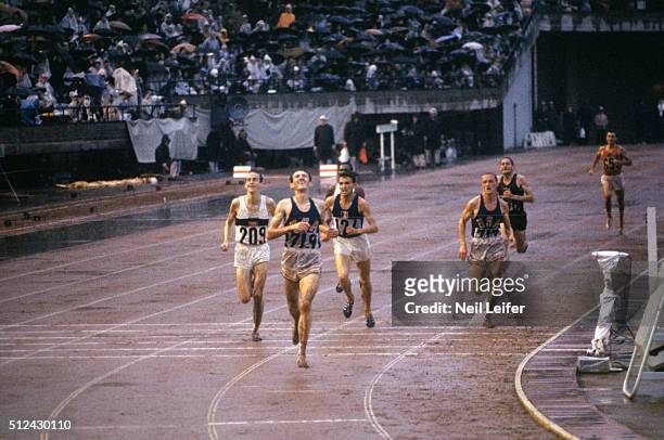 Summer Olympics: USA Bob Schul victorious at finish line winning Men's 5000M Final gold at National Olympic Stadium. West Germany Harald Norpoth won...
