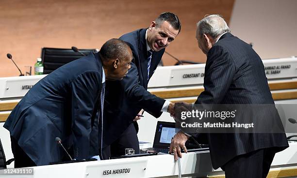 Former President of UEFA Lennart Johansson shakes hands with FIFA Acting President Issa Hayatou and FIFA Acting Secretary General Markus Kattner...