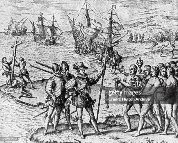 Christopher Columbus lands on Watling Island and meets the natives, while three of his shipmates erect a cross.