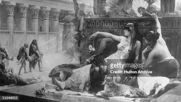 Circa 40 BC, Queen Cleopatra of Egypt testing poison on slaves. Original Artwork: Painting by Colonel