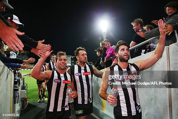 Jarryd Blair of the Magpies Dane Swan and Alex Fasolo of the Magpies celebrate the win with fans during the 2016 NAB Challenge match between the...