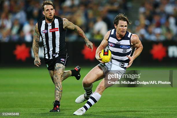 Patrick Dangerfield of the Cats runs with the ball away Dane Swan of the Magpies during the 2016 NAB Challenge match between the Geelong Cats and the...