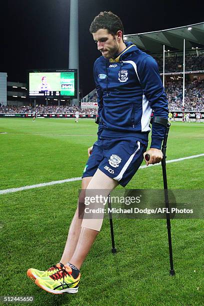 Sam Menegola of the Cats walk off on crutches after sustaininig a leg injury during the 2016 NAB Challenge match between the Geelong Cats and the...