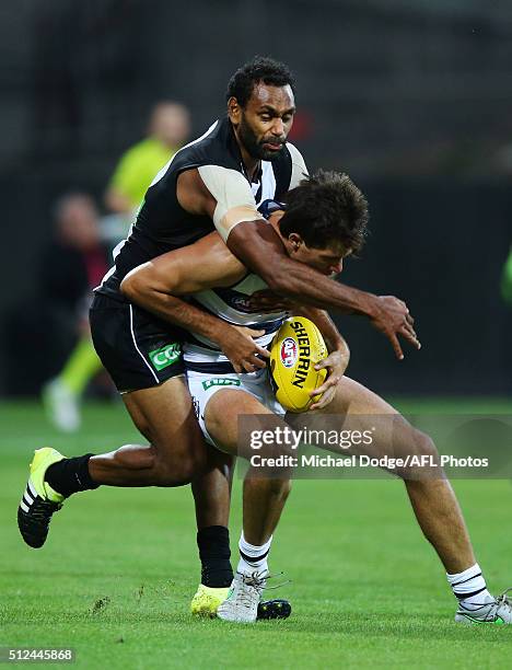 Travis Varcoe of the Magpies tackles Andrew Mackie of the Cats during the 2016 NAB Challenge match between the Geelong Cats and the Collingwood...
