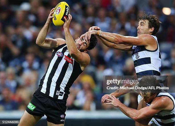 Alex Fasolo of the Magpies marks the ball against Corey Enright and Jed Bews during the 2016 NAB Challenge match between the Geelong Cats and the...