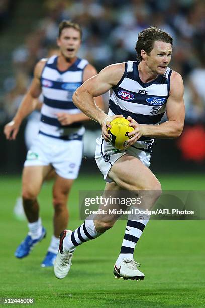 Patrick Dangerfield of the Cats runs with the ball during the 2016 NAB Challenge match between the Geelong Cats and the Collingwood Magpies at...