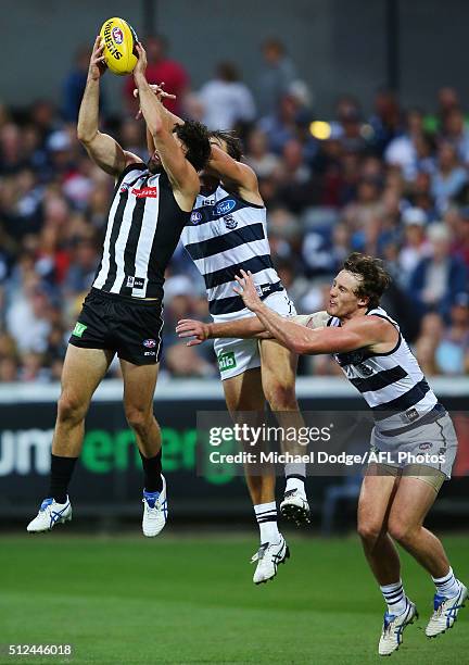Alex Fasolo of the Magpies marks the ball against Corey Enright and Jed Bews during the 2016 NAB Challenge match between the Geelong Cats and the...