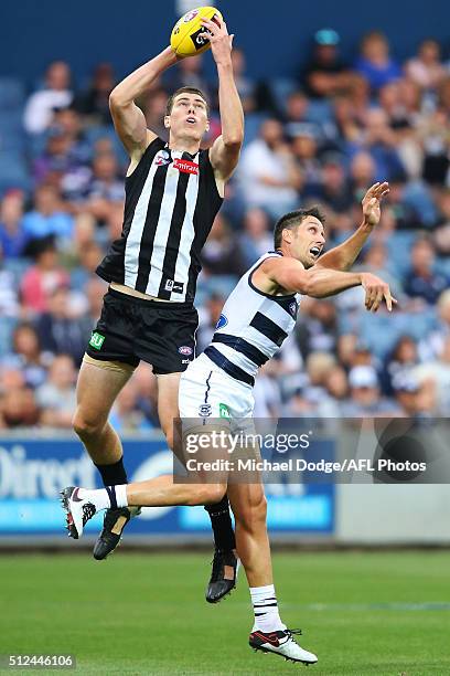 Mason Cox of the Magpies marks the ball over Harry Taylor of the Cats during the 2016 NAB Challenge match between the Geelong Cats and the...
