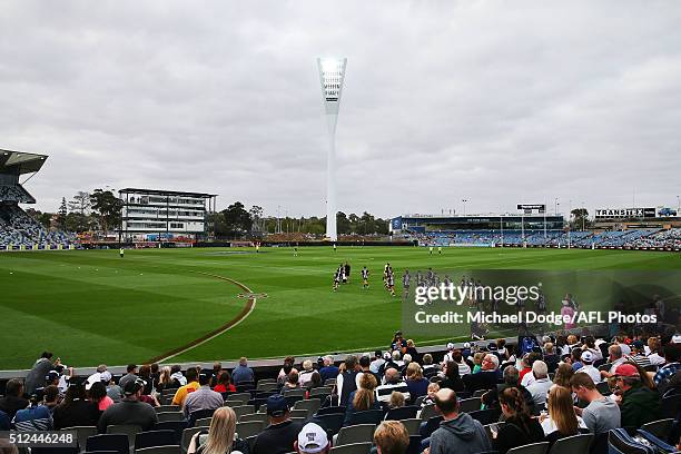 Magpies players run out in front of the demolished stand during the 2016 NAB Challenge match between the Geelong Cats and the Collingwood Magpies at...