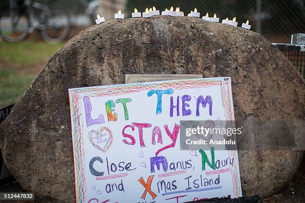 Placard is placed at the entrance of the refugee detention centre during a candlelight vigil as protestors stand in solidarity with refugees in...