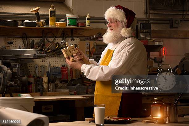 santa claus working in his workshop - santas workshop stock pictures, royalty-free photos & images