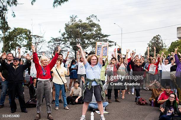 Protestors cheer and shout while holding placards outside a detention centre in Melbourne during a candlelight vigil as protestors stand in...
