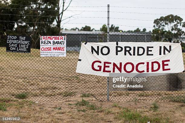Banners relating to the closure of the Manus Island detention centre, Reza Barati and Aboriginal Genocide hung at the gates of a refugee detention...