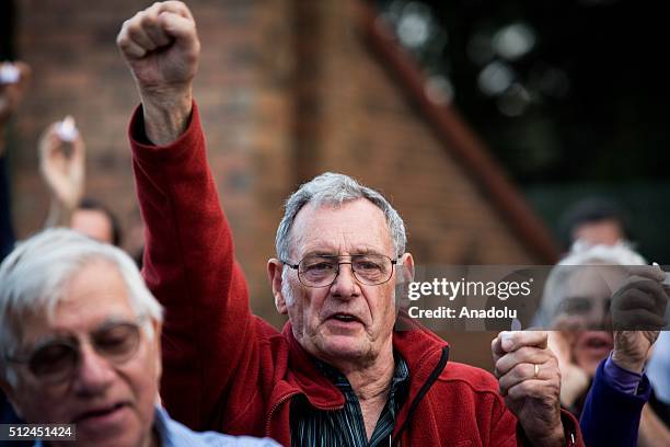 Protestor raises his clenched fist during a candlelight vigil as protestors stand in solidarity with refugees in detention in Melbourne, Australia...