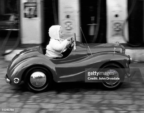 December 1963, 18-month-old Fiona Egglestone of Penrith in Cumbria learns to drive in a motorised Austin pedal car. Her father Harold made the car...