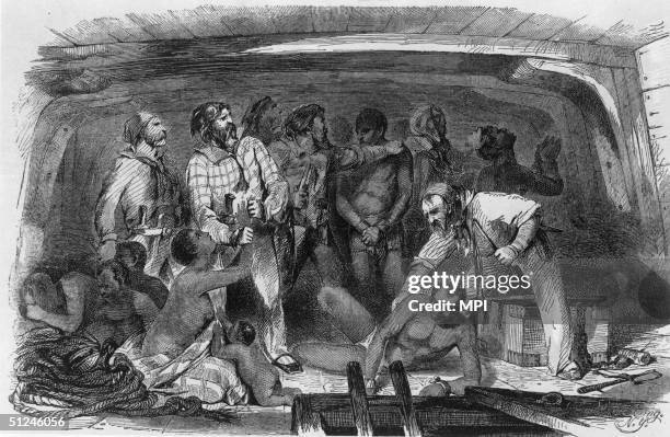 Circa 1750, Cargo is stowed away on a slave ship by night.