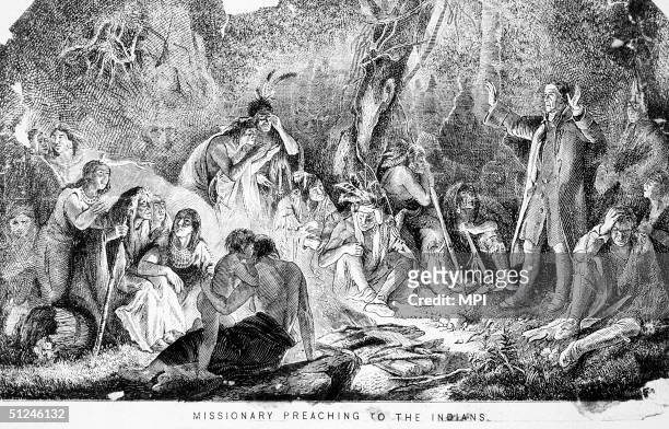Circa 1740, A Moravian Church missionary preaching to a group of Native American Indians in Pennsylvania.