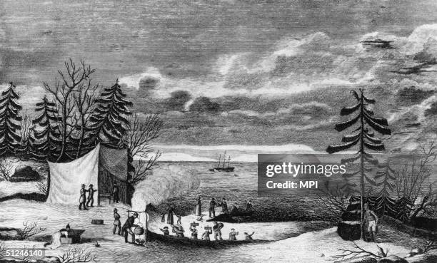 21st December 1620, The pilgrim fathers make camp at Plymouth Colony upon their arrival in America. Their ship, the Mayflower lies at anchor in the...