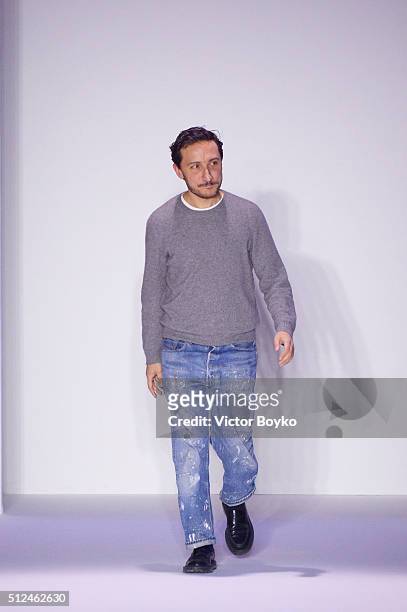 Designer Marco De Vincenzo ackowledges the applause of the audience at the end of the Marco De Vincenzo show during Milan Fashion Week Fall/Winter...