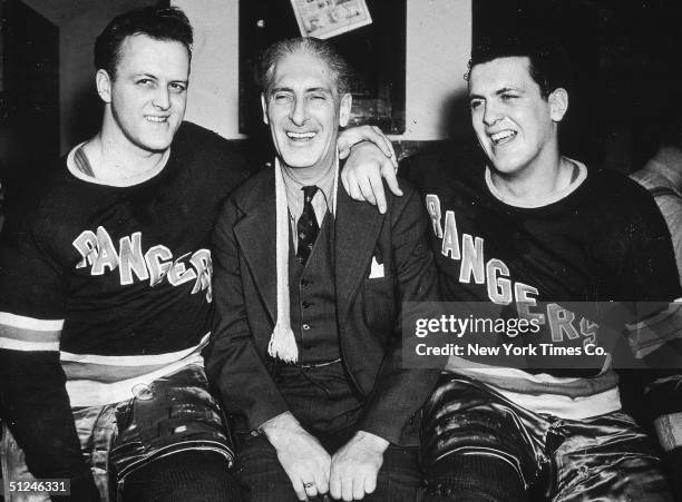 Circa 1940, New York Rangers hockey team manager Lester Patrick posing with his sons, Rangers players Lynn, left, and Muzz.