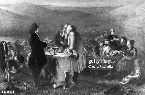 Circa 1670, A Presbyterian Minister blessing two chalices on a makeshift altar whilst congregation members take the Sacrament at a Covenanters'...