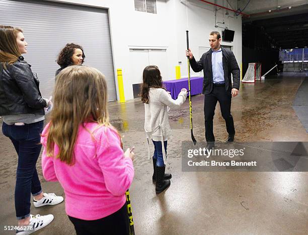 Max Nicastro of Orlando Solar Bears gives a fan a stick following a game at the Amway Center on February 13, 2016 in Orlando, Florida.