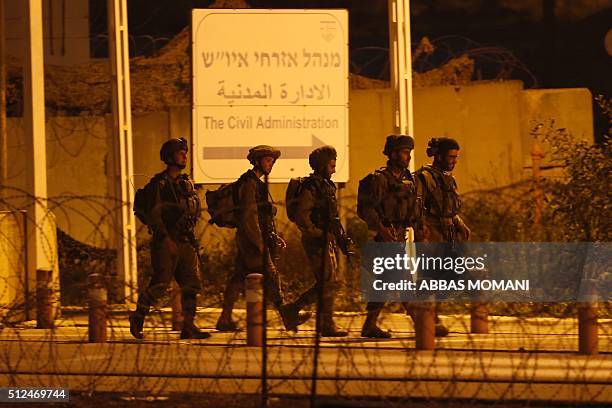 Israeli security forces monitor the area where a Palestinian man tried to stab Israeli soldiers before being shot dead at a checkpoint near Ramallah,...