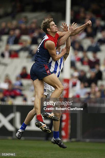 Jared Rivers for the Demons spoils a mark over his Kangaroos opponent during the round nine AFL match between the Melbourne Demons and the Kangaroos...