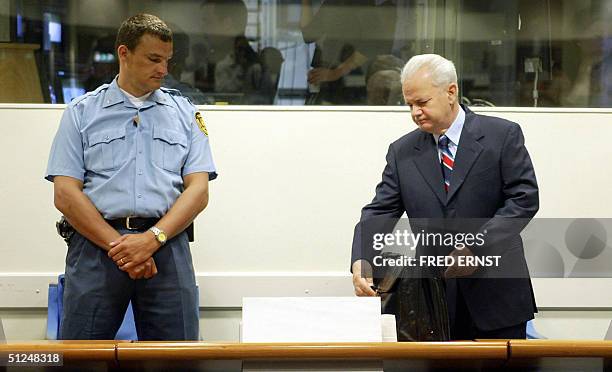 Former Yugoslav President Slobodan Milosevic enters the courtroom of the United Nation tribunal in The Hague 31 August 2004. Milosevic began his...