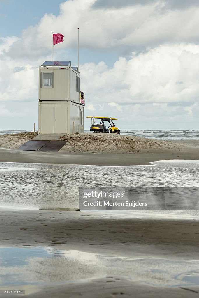 Dutch Coastguard hut on wet beach