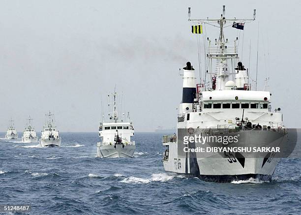 Members of the Indian Coast Guard steer their crafts during a demonstration in the Bay Of Bengal some 60 kms east of Madras, 31 August 2004. The...