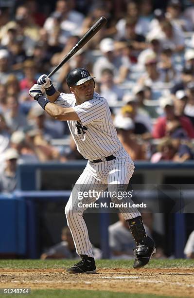 Infielder Derek Jeter of the New York Yankees swings at a Toronto Blue Jays pitch during the game at Yankee Stadium on August 9, 2004 in the Bronx,...