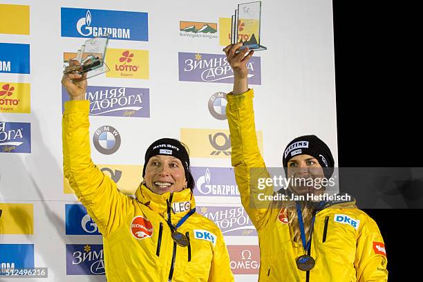 Anja Schneiderheinze andAnnika Drazek pose for a picture during the flower ceremony of the two-women bobsleigh competition during the BMW IBSF Bob &...