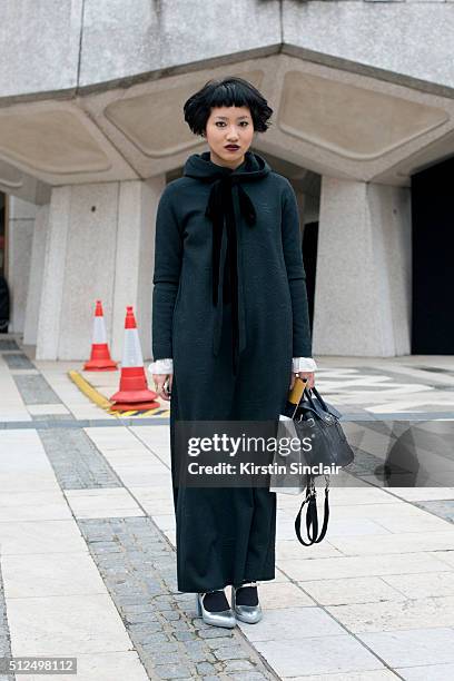 Numero Thailand fashion director Fame Boonyasit wears a Yoji Yamamoto dress, Prada shoes and Mulberry bag on day 3 during London Fashion Week...