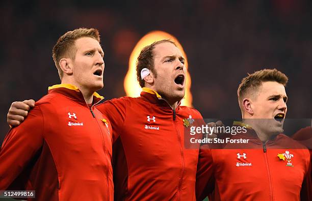 Bradley Davies, Alun Wyn Jones and Jonathan Davies of Wales sing the national anthem prior to kickoff during the RBS Six Nations match between Wales...