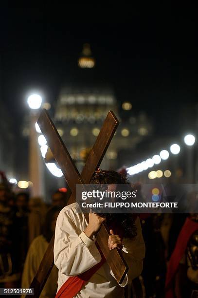 Man reenacts the way of the cross by Jesus Christ on Via della Conciliazione leading from St.Peter's Basilica at the Vaticano in Rome on February 26,...