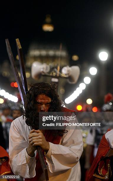 Man reenacts the way of the cross by Jesus Christ on Via della Conciliazione leading from St.Peter's Basilica at the Vaticano in Rome on February 26,...