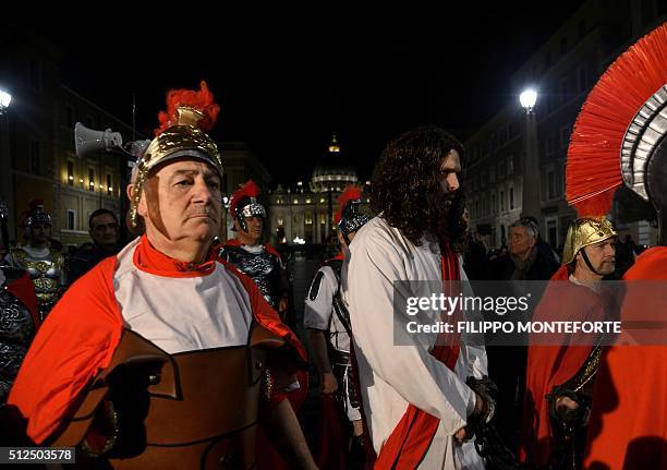 Men reenact the way of the cross by Jesus Christ on Via della Conciliazione leading from St.Peter's Basilica at the Vaticano in Rome on February 26,...