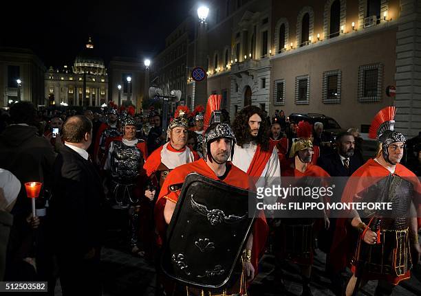 Men reenact the way of the cross by Jesus Christ on Via della Conciliazione leading from St.Peter's Basilica at the Vaticano in Rome on February 26,...