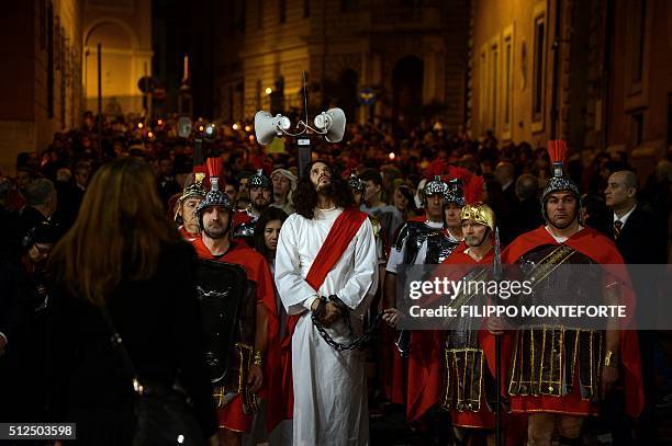 People reenact the way of the cross by Jesus Christ on Via della Conciliazione leading from St.Peter's Basilica at the Vaticano in Rome on February...
