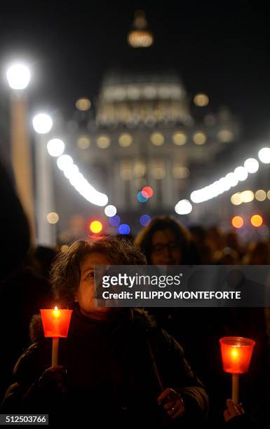 Faithfull follows the way of the cross by Jesus Christ on Via della Conciliazione leading from St.Peter's Basilica at the Vaticano in Rome on...